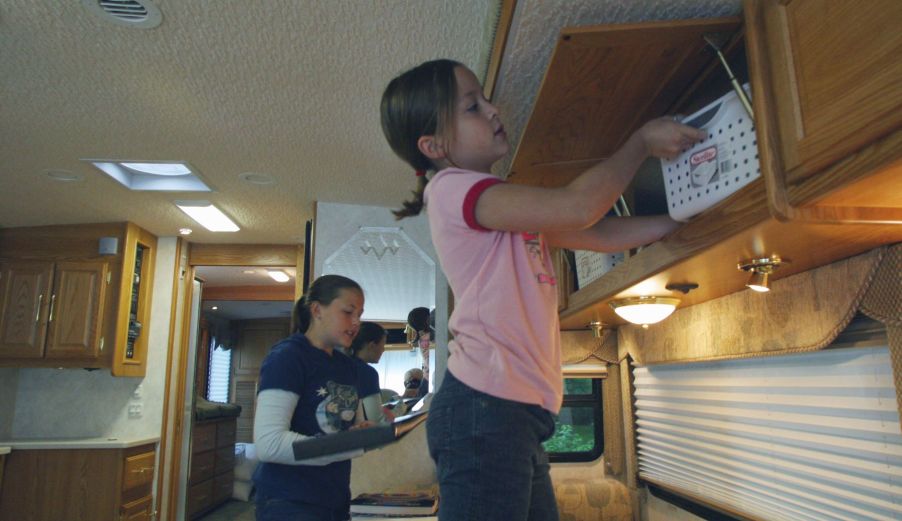 Stowing school supplies in RV storage compartments in Minnetonka, Minnesota