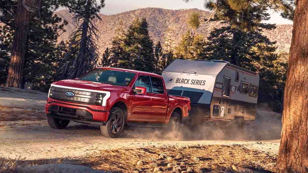 Red Ford F-150 Lightning Towing a Trailer