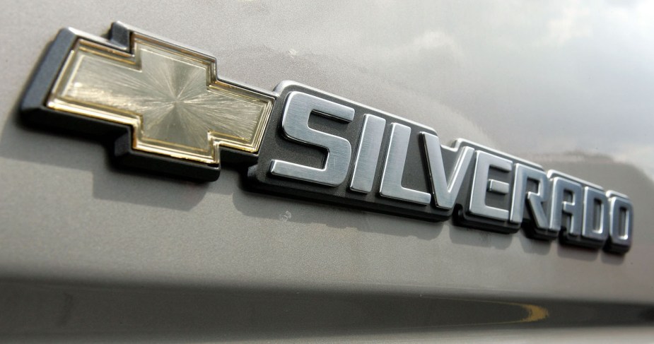 Closeup of the Chevrolet Bowtie and Silverado logo on the size of a reliable used half-ton General Motors 1500 pickup truck.