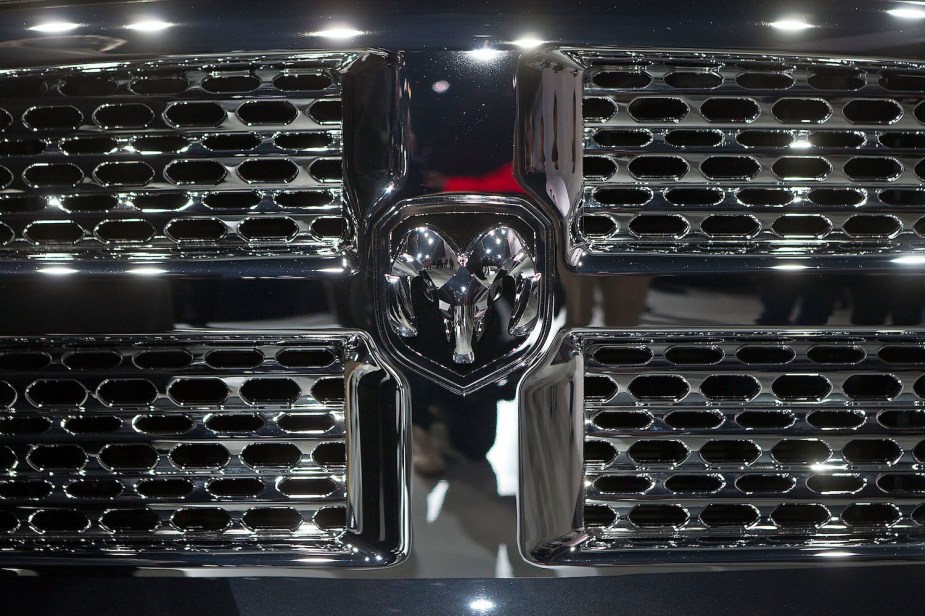 Detail of the Ram longhorn logo placed in the chrome crosshair grille of a reliable used Dodge truck built by Fiat Chrysler Automobiles.