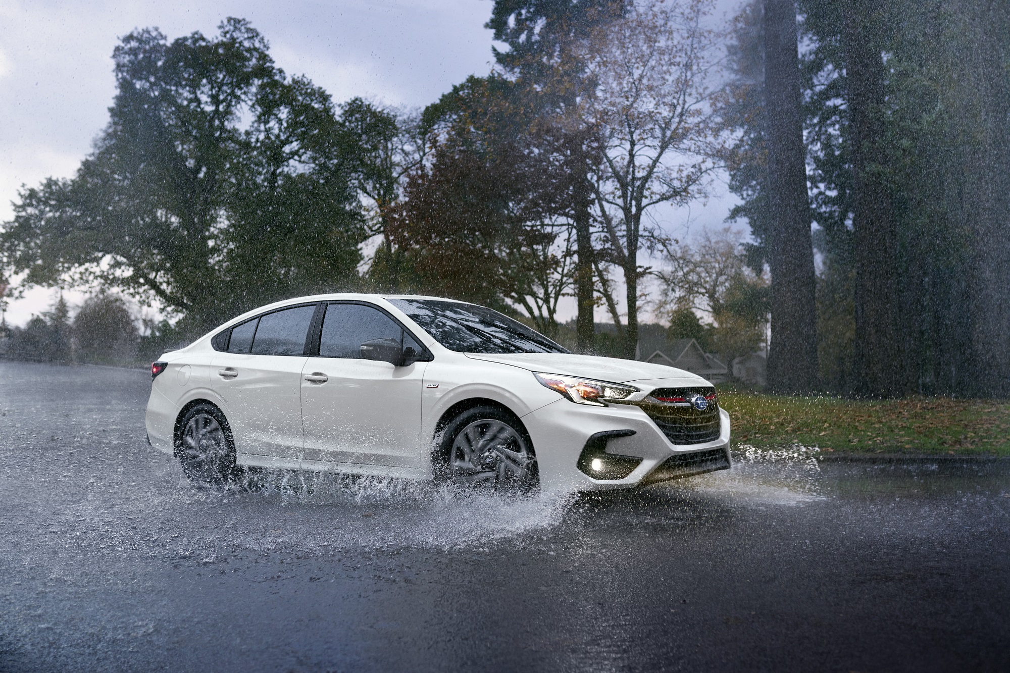A fully loaded 2023 Subaru Legacy kicks up water with its standard Subaru AWD system.