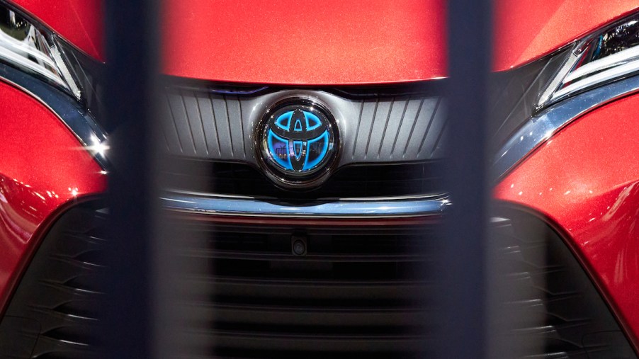 The front end of a red Toyota Prius.