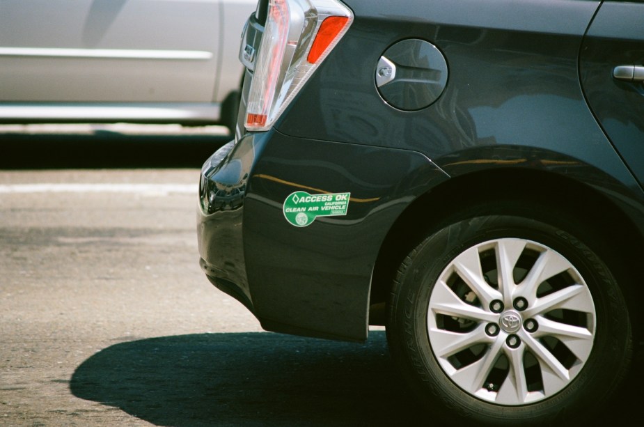Close-up of the carpool access sticker on a Toyota Prius plug-in hybrid's bumper.