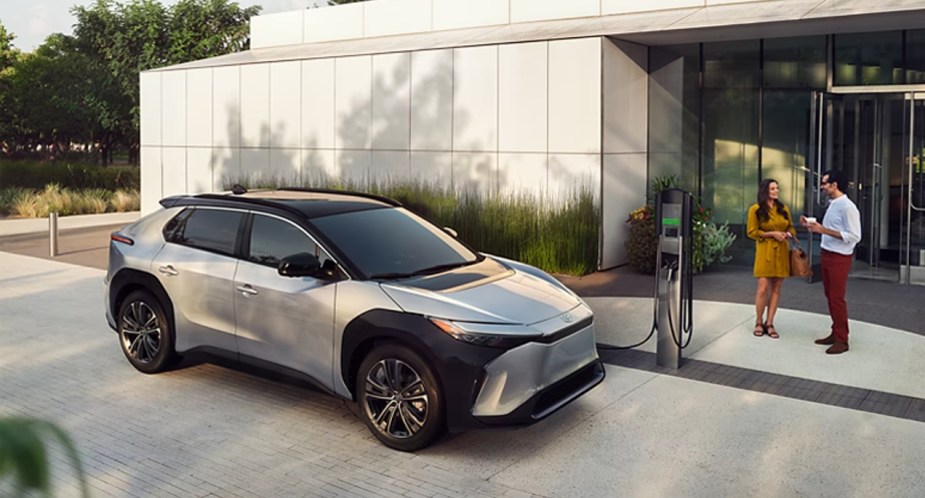 A gray 2023 Toyota bZ4X small electric SUV is charging.