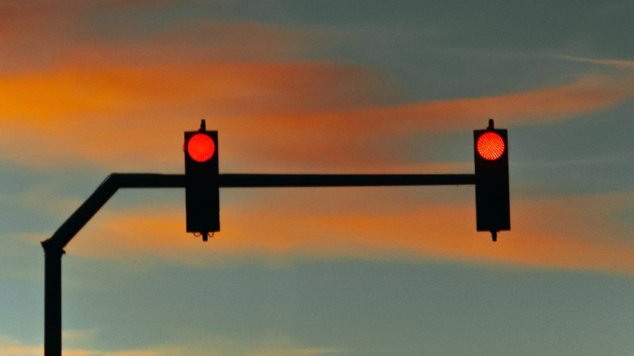 Two red lights with a sunset, highlighting DC ban on cars from making right turns at red lights