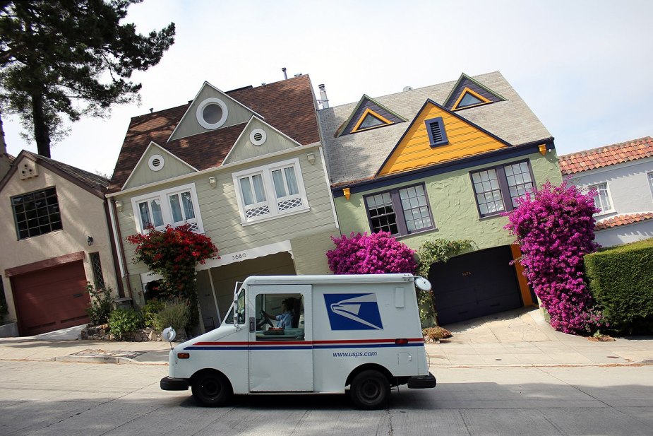 A USPS mail truck sits on the road, there has been an uptick in robberies of mail trucks.