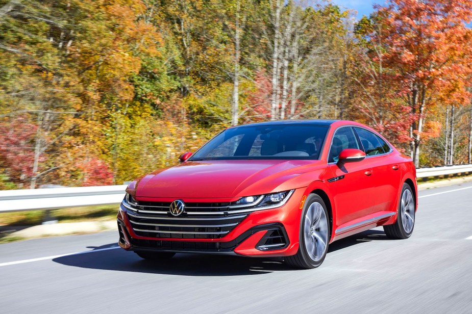 A red 2023 VW Arteon driving in the fall is one of the safest cars. 