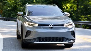 A gray Volkswagen ID.4 is driving on the road.