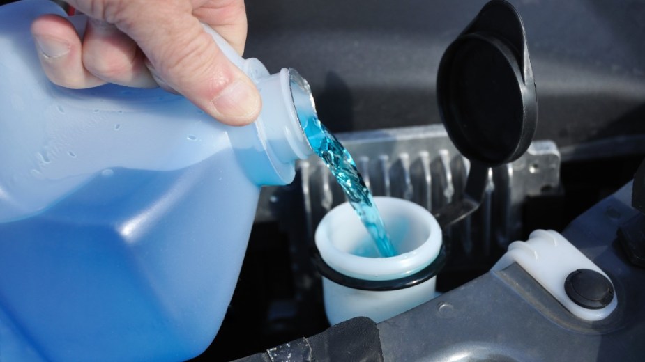 Windshield Washer Fluid Being added to a Car
