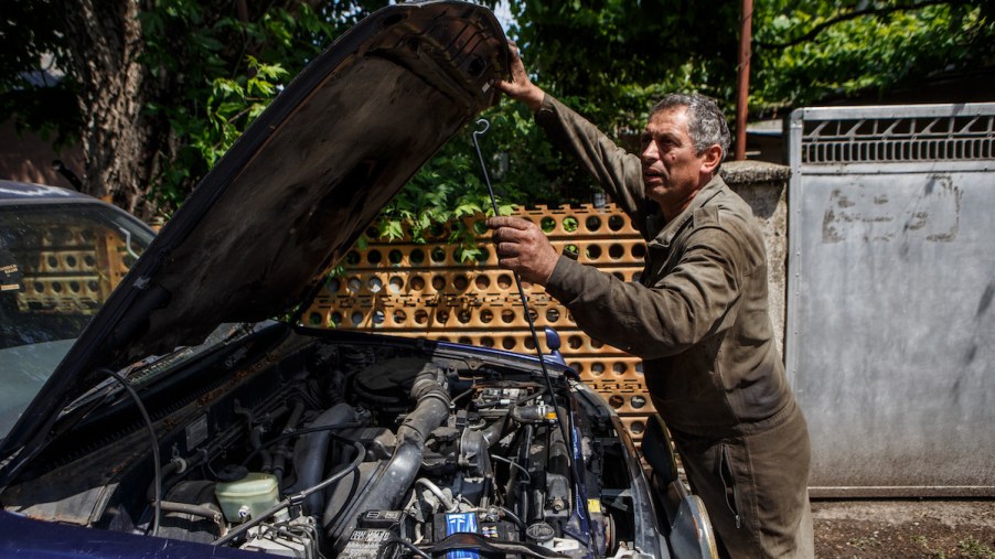A mechanic potentially exercising the right to repair law by repairing his vehicle himself.