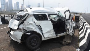 A white car involved in a car accident in need of insurance to process claims regarding the accident.