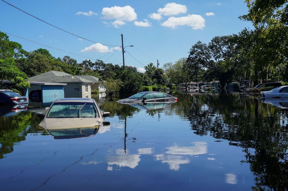 Cars submerged on a city street after Hurricane Ian.