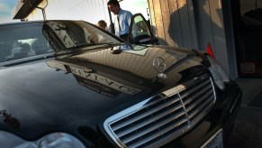 Agent Alen Zare helps a customer as he checks out a Mercedes at the luxury Beverly Hills Rent A Car.