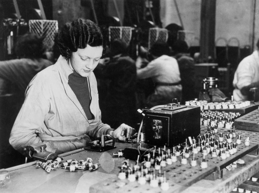 A factory worker testing KLG spark plugs in the United Kingdom (U.K.) in 1939