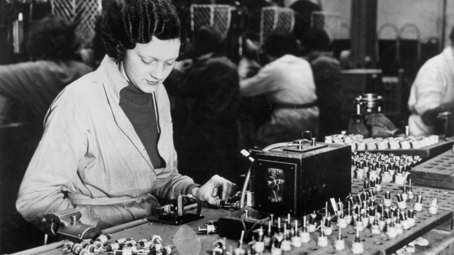 A factory worker testing KLG spark plugs in the United Kingdom (U.K.) in 1939