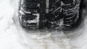 A close-up of a winter tire in snow