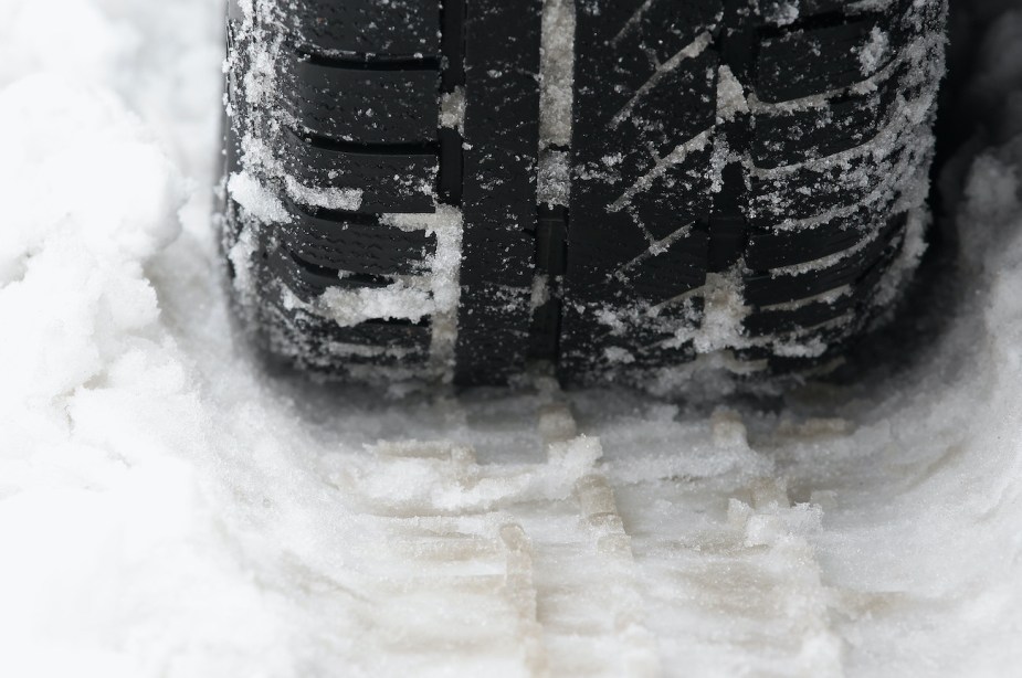 A close up of a winter tire in the snow.