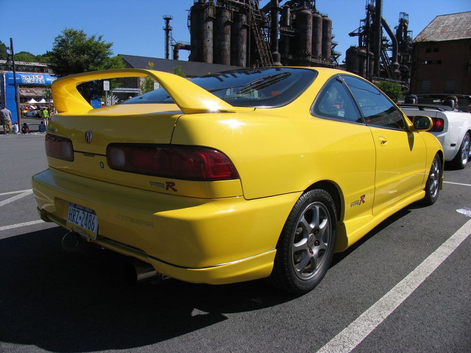 The rear view of a yellow Acura Integra Type R