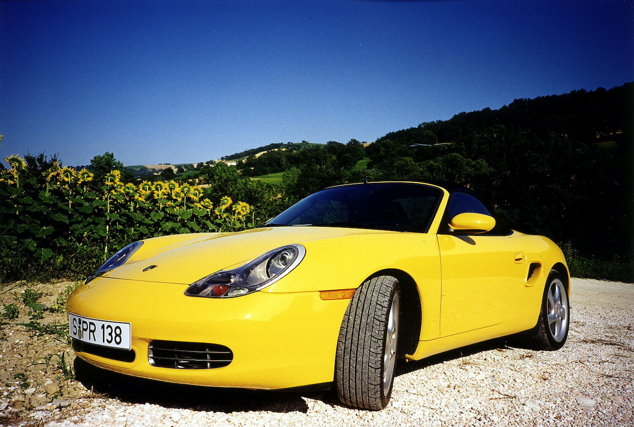 A yellow 986 Porsche Boxster
