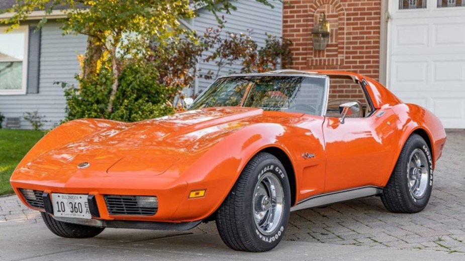 Orange 1975 Chevy Corvette parked in front of house
