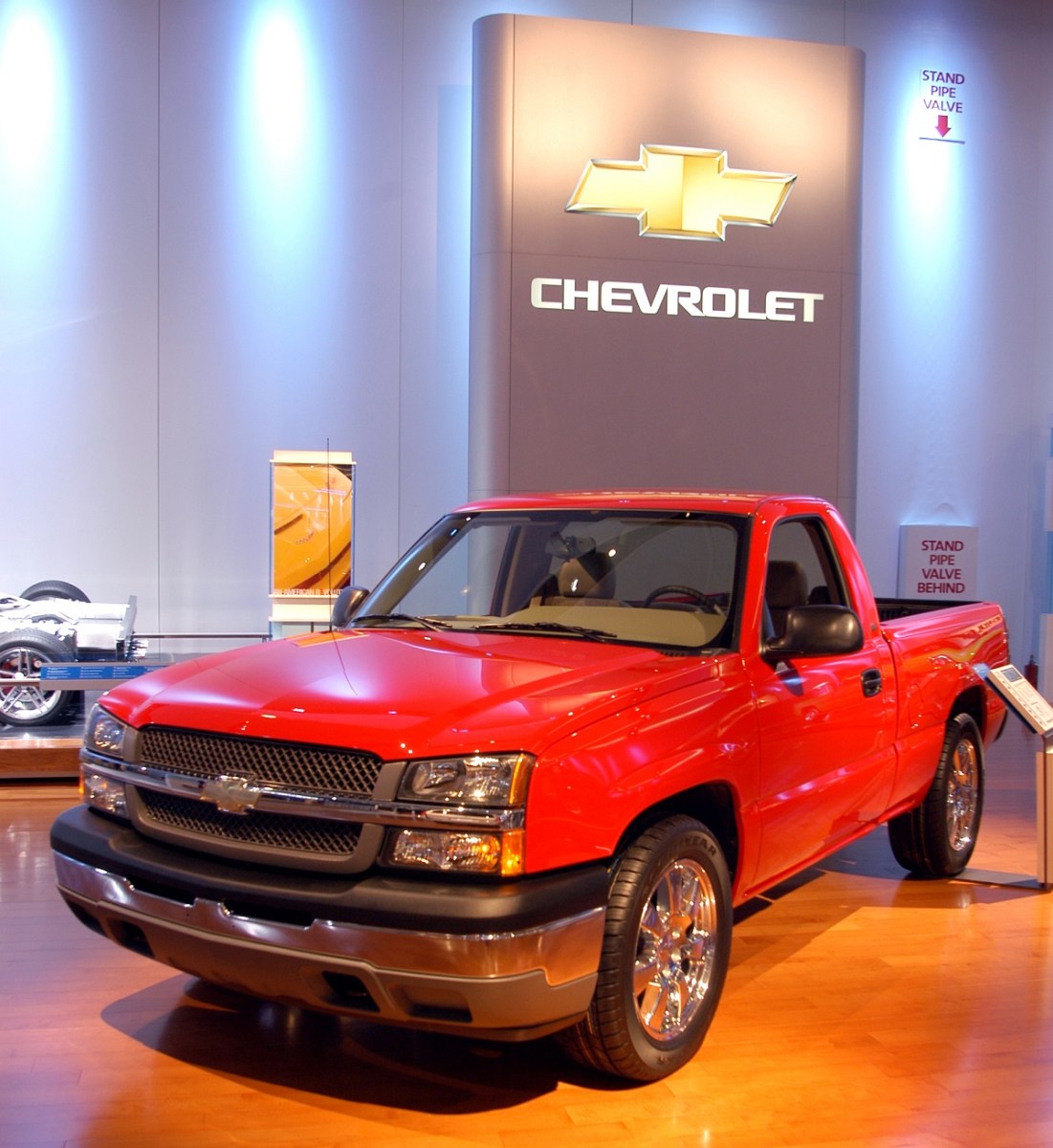 2005 Chevy Silverado in red at an auto show