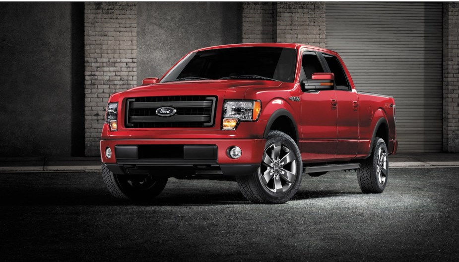 Promotional photo of a red Ford F-150 pickup truck parked in front of a brick wall.