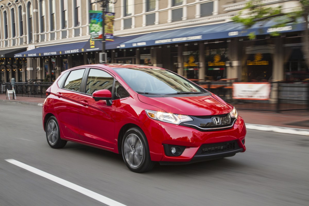 A red 2016 Honda Fit driving, the Fit is U.S. News' pick for the best used car under $15,000