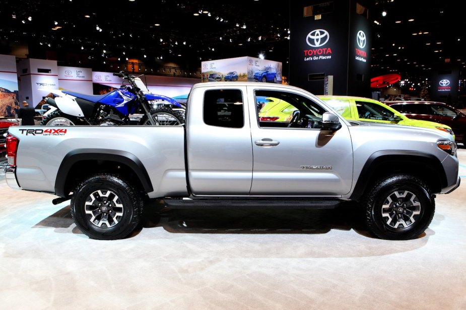 Silver 2017 Toyota Tacoma TRD 4x4 midsize pickup truck parked in a row of vehicles at an auto show.