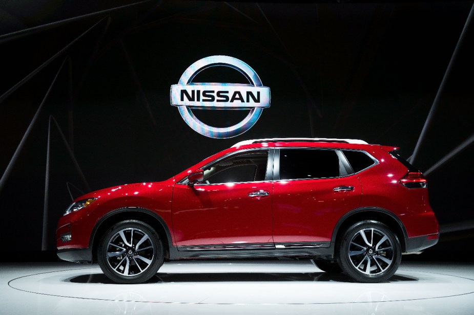 A red 2018 Nissan Rogue SUV is on display.