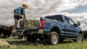 Promo photo of a blue Ford Super Duty pickup truck parked in a field.