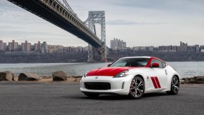 A red and white 2020 Nissan 370Z 50th Anniversary Edition parked near a bridge