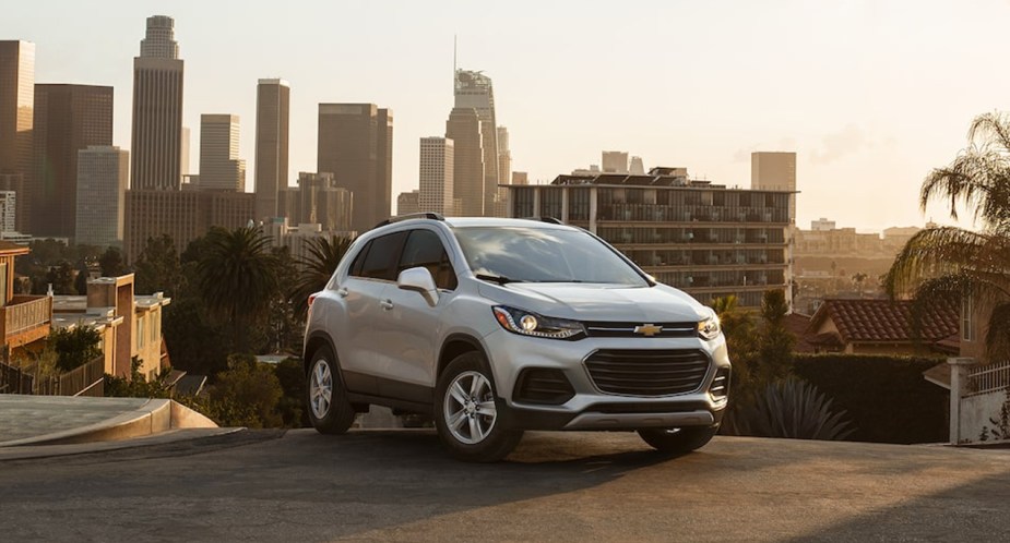 A white 2022 Chevrolet Trax subcompact SUV is parked on a hill. 