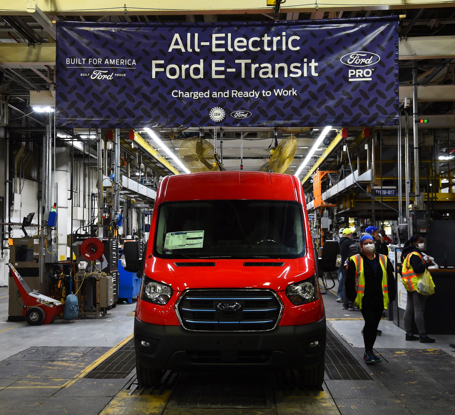 A red 2022 Ford E-Transit all-electric (EV) cargo passenger van on the production/assembly line