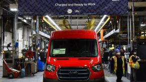 A red 2022 Ford E-Transit all-electric (EV) cargo passenger van on the production/assembly line
