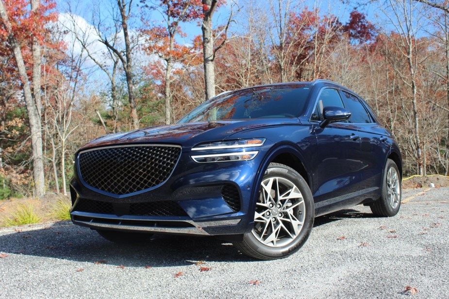 A blue 2022 Genesis GV70 small luxury SUV is parked. 