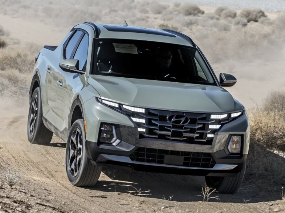 2022 Hyundai Santa Cruz compact truck driving outside on dirt