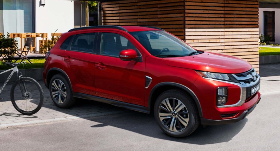 A red 2022 Mitsubishi Outlander Sport is parked outside. 
