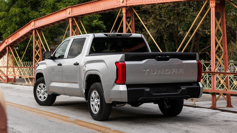 A silver, third generation Toyota Tundra parked on a bridge, facing away from the camera.