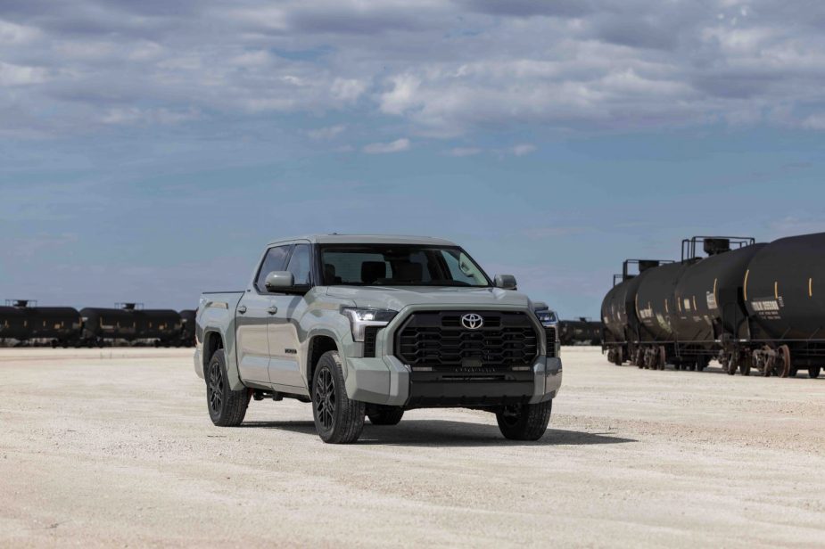 A gray 2022 Toyota Tundra SR5 pickup truck parked in a train yard for a promo photo.