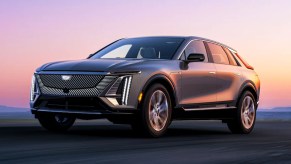 A gray 2023 Cadillac LYRIQ luxury electric SUV is driving.