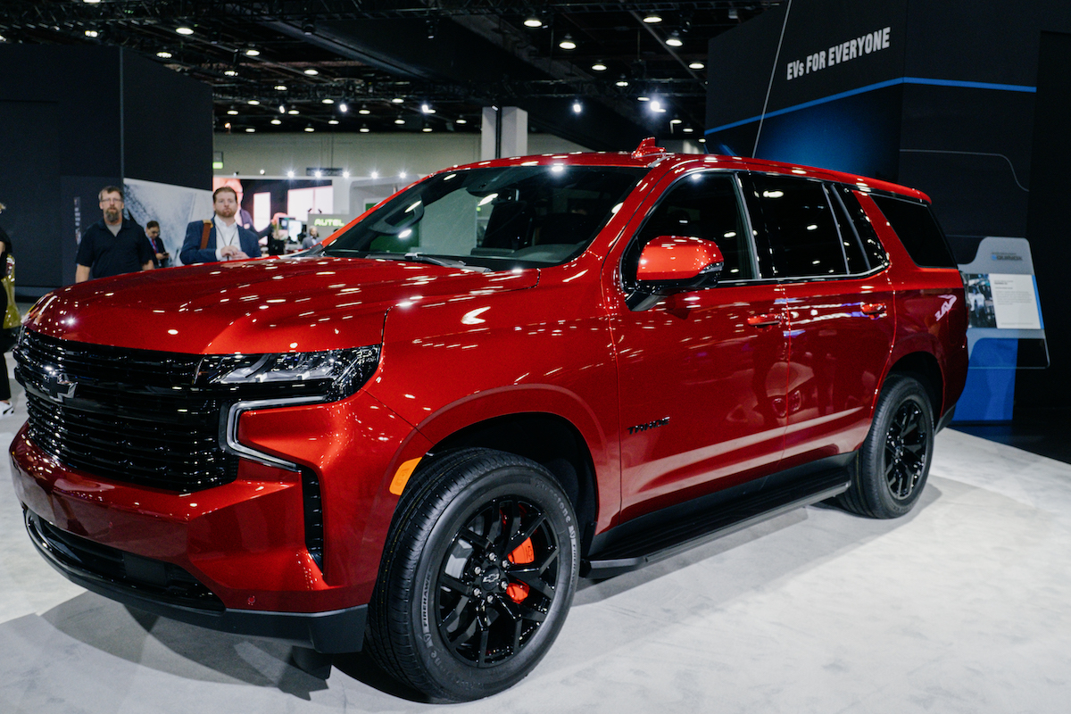 A red 2023 Chevrolet Tahoe parked indoors.
