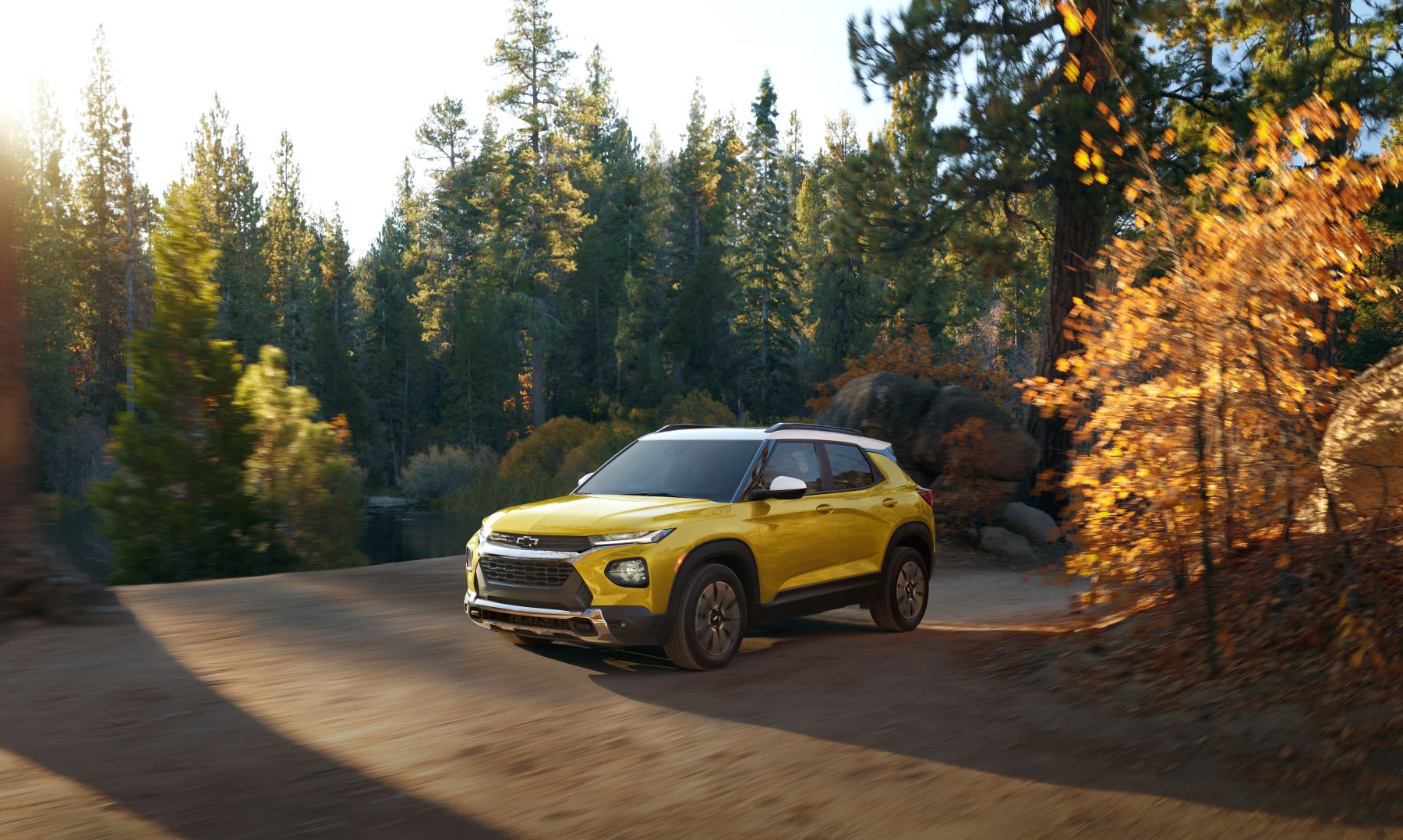 2023 Chevrolet Trailblazer subcompact crossover SUV in Nitro Yellow driving on a forest road