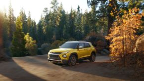 2023 Chevrolet Trailblazer subcompact crossover SUV in Nitro Yellow driving on a forest road