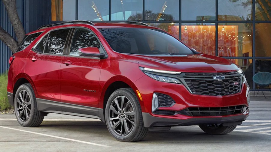 A red 2023 Chevrolet Equinox small SUV is parked.