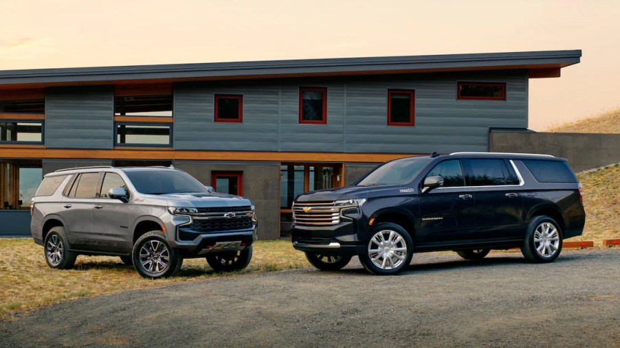 A 2023 Chevy Tahoe parked next to a Suburban. The full-size SUV family from Chevrolet.