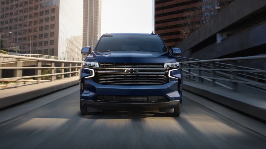 a blue 2023 chevy tahoe driving on a highway. Check out our guide to every trim level.