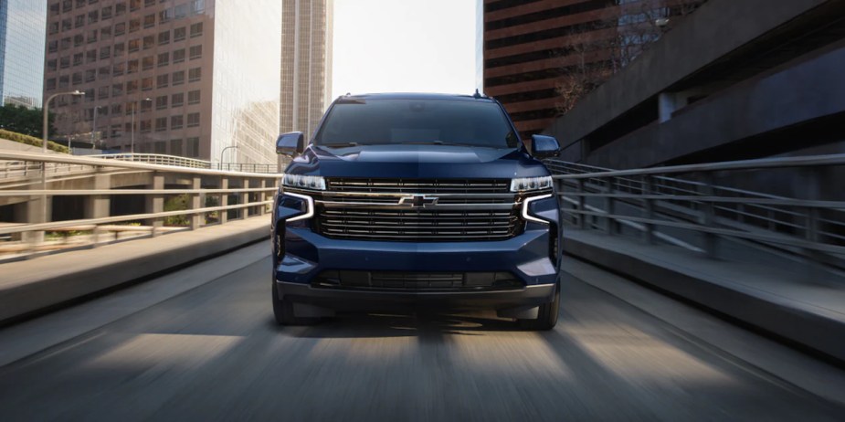 a blue 2023 chevy tahoe being driven on a highway.  Check out our guide for each trim level.