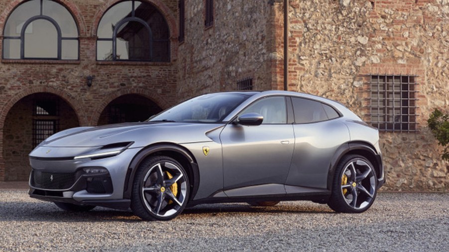 A gray 2023 Ferrari Purosangue luxury performance SUV is parked outside.