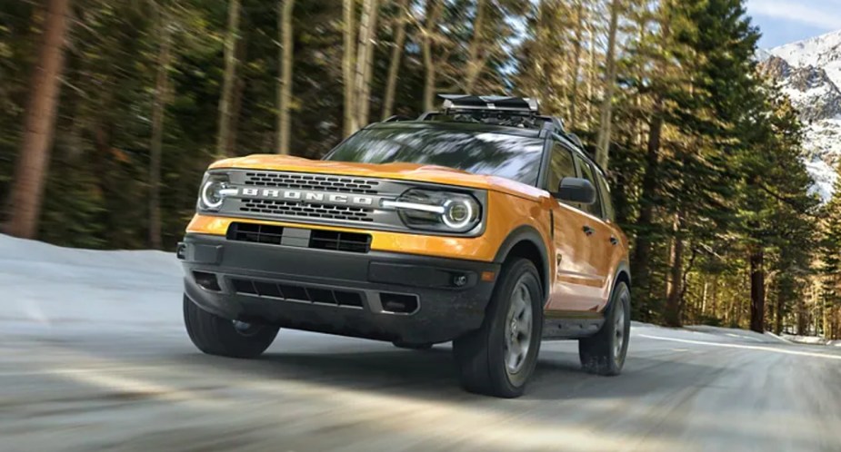 A yellow 2023 Ford Bronco Sport drives down the highway. 