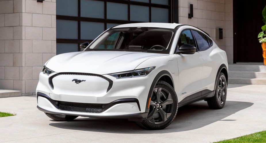 A white 2023 Ford Mustang Mach-E small electric SUV is parked. 